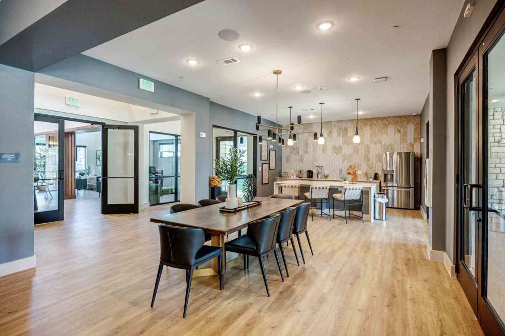 Long wooden table sits in a modern communal space at The Abbey at Veramendi in New Braunfels, Texas