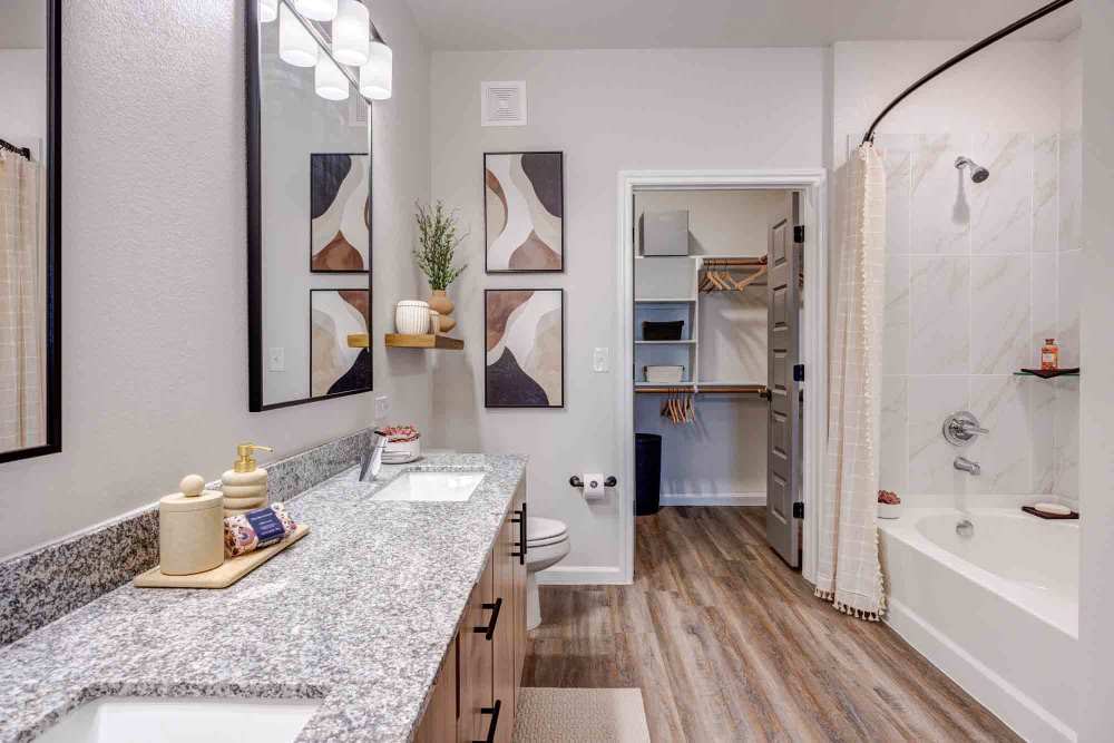 Granite-topped double vanity in a modern bathroom at The Abbey at Veramendi in New Braunfels, Texas