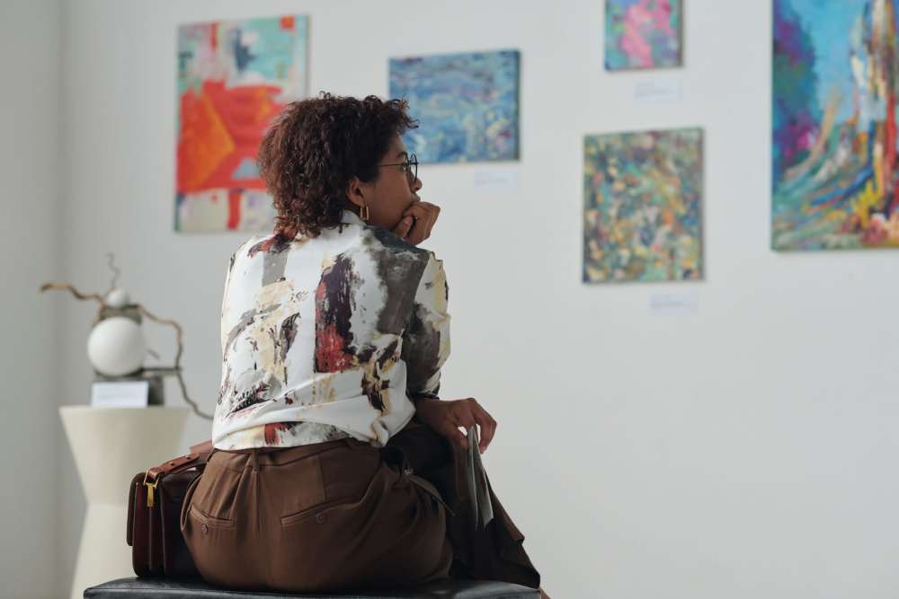 Woman looking at art gallery near Detroit Living in Detroit, 