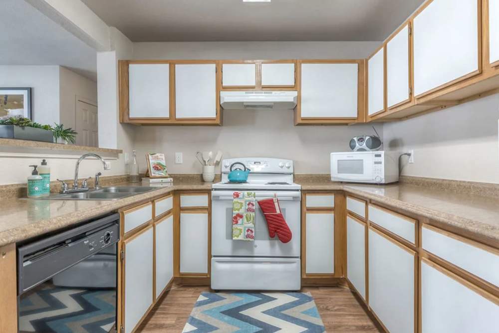 Kitchen with a dishwasher at Villas at Bailey Ranch Apartment Homes in Owasso, Oklahoma