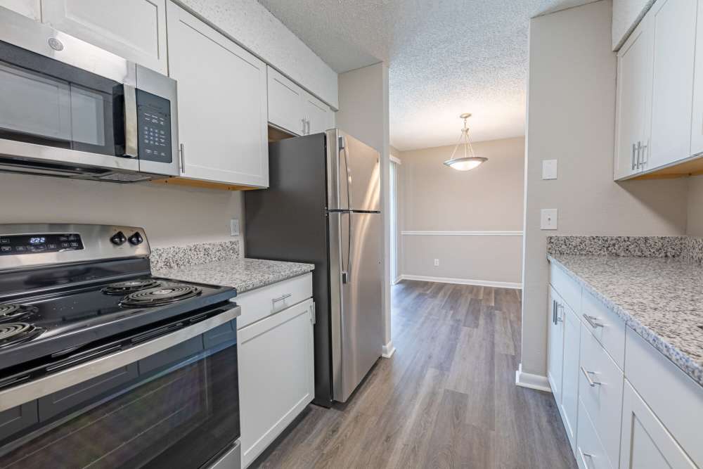Spacious kitchen with wood-style flooring at Huffman Mill Townhomes in Burlington, North Carolina,