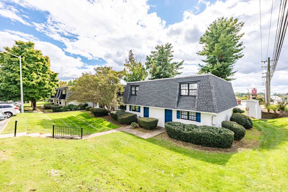 Grassy walking path with trees surrounding at Huffman Mill Townhomes in Burlington, North Carolina,