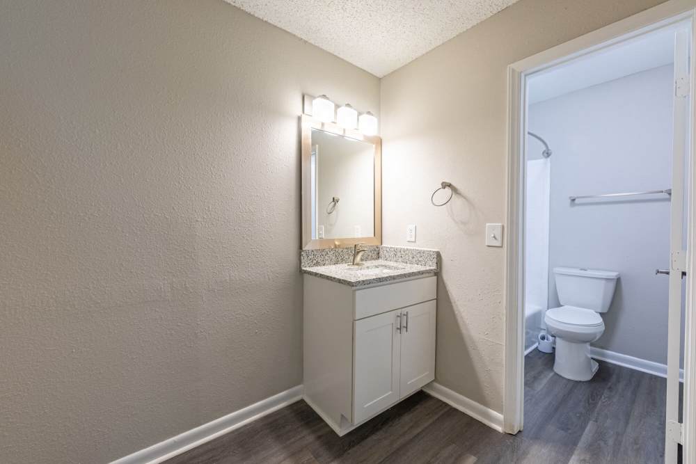 Bathroom with large mirror and pendant lighting at Huffman Mill Townhomes in Burlington, North Carolina,