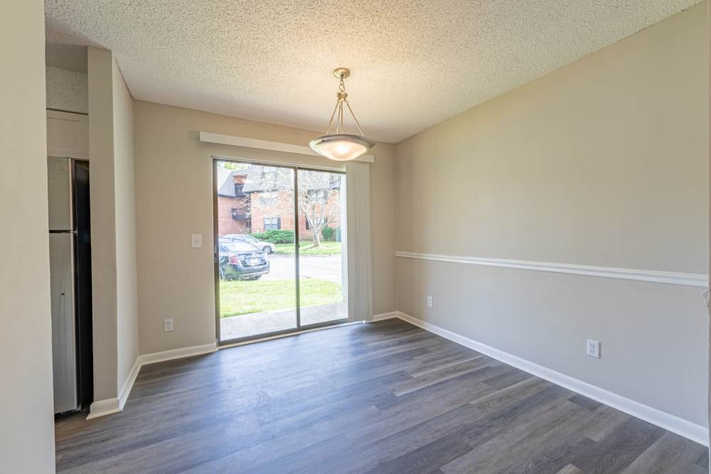 Spacious living room with access to patio through glassdoor at Huffman Mill Townhomes in Burlington, North Carolina,