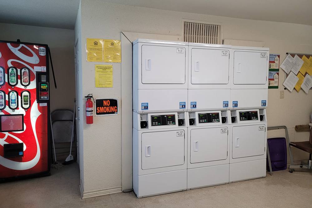 Laundry room dryers at Southwood Apartments in Shepherd, Texas