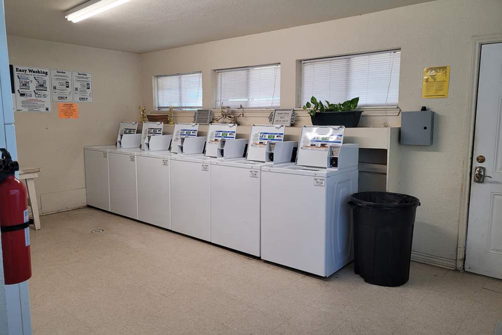 Laundry room washers at Southwood Apartments in Shepherd, Texas