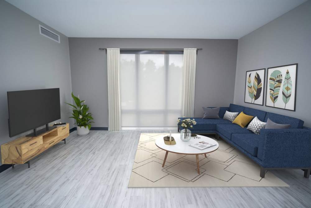 A living space showcasing a stylish blue sofa and contemporary furnishings at Diamond Place I in Grand Rapids, Michigan