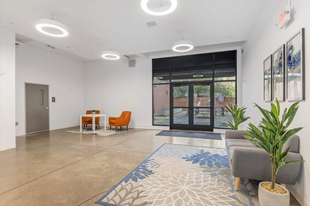 Modern lobby with circular ceiling lights and potted plants near glass doors at Koz on Killingsworth in Portland, Oregon