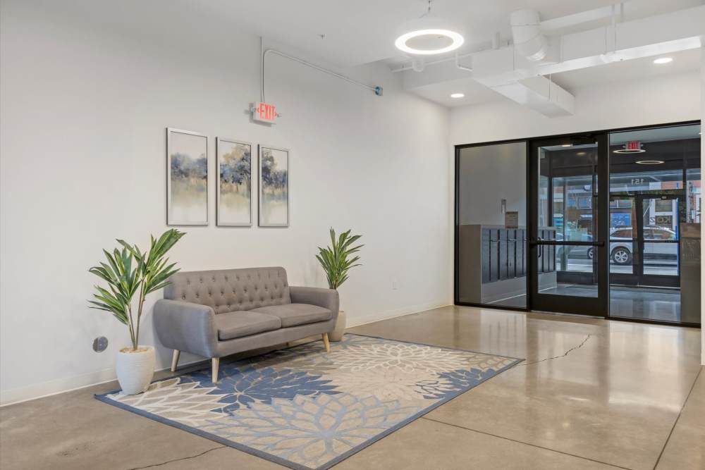 Modern lobby with a gray sofa at Koz on Killingsworth in Portland, Oregon