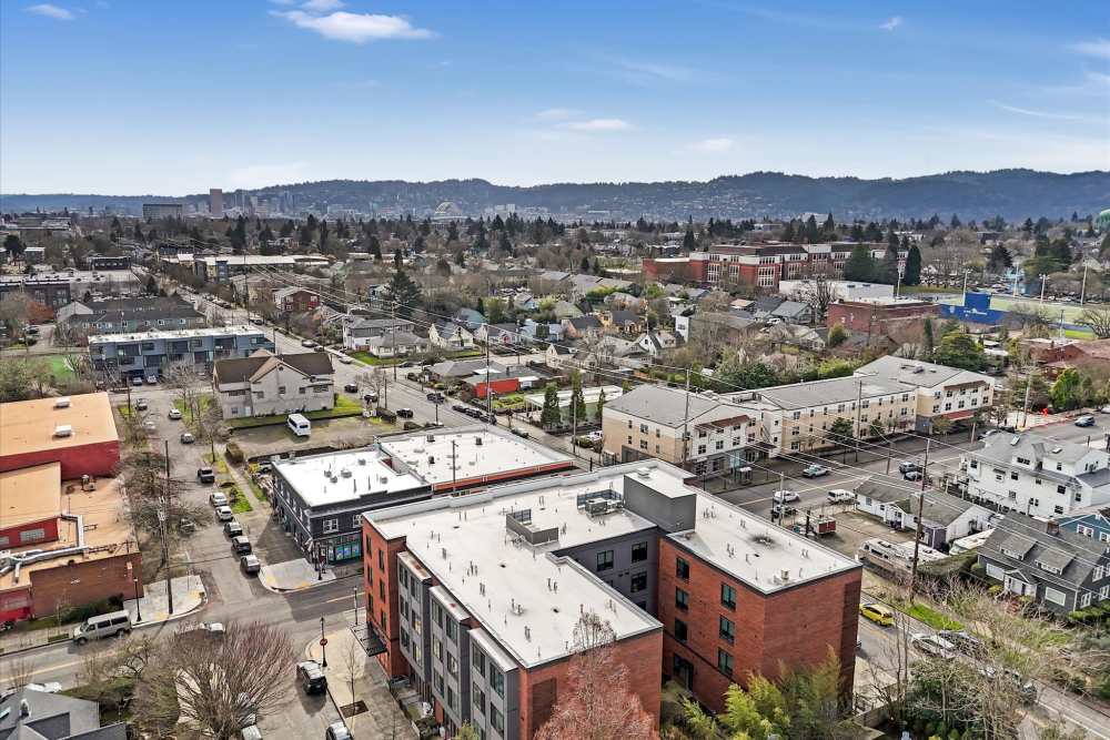 Aerial view of a vibrant urban neighborhood with modern brick buildings at Koz on Killingsworth in Portland, Oregon