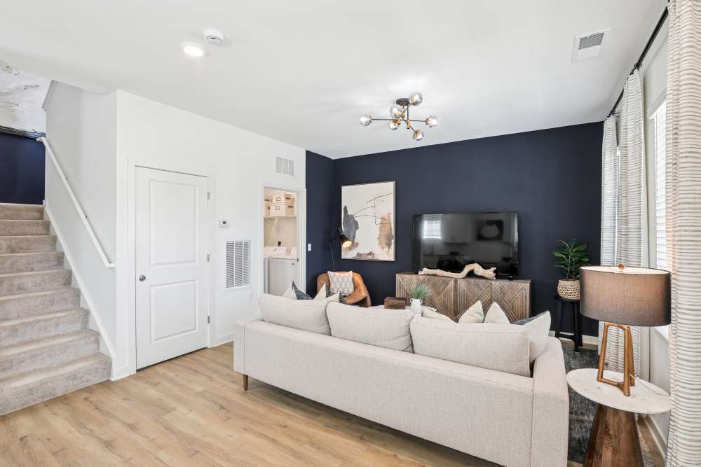 Living room with dark wall and creme colored sofa at Hamlet Falling Creek in Midlothian, Virginia