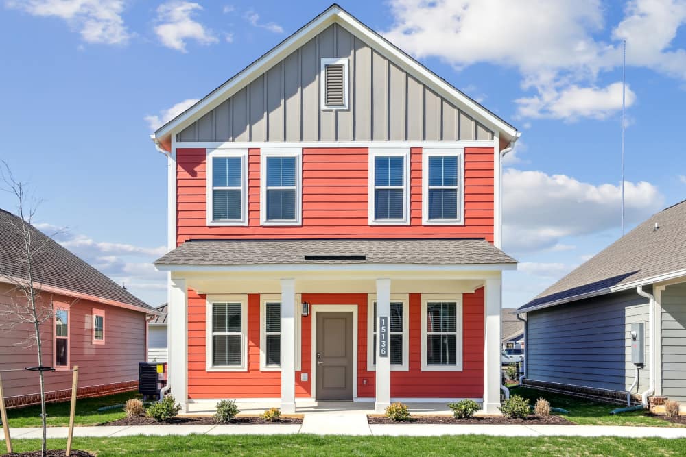 Exterior view of orange multi-level home at Hamlet Falling Creek in Midlothian, Virginia