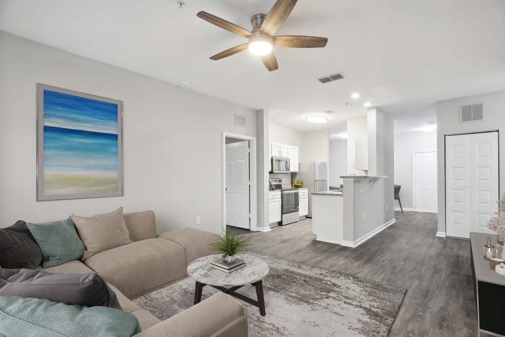 Bright living room with a ceiling fan and a coffee table at The Haven At West Melbourne in West Melbourne, Florida