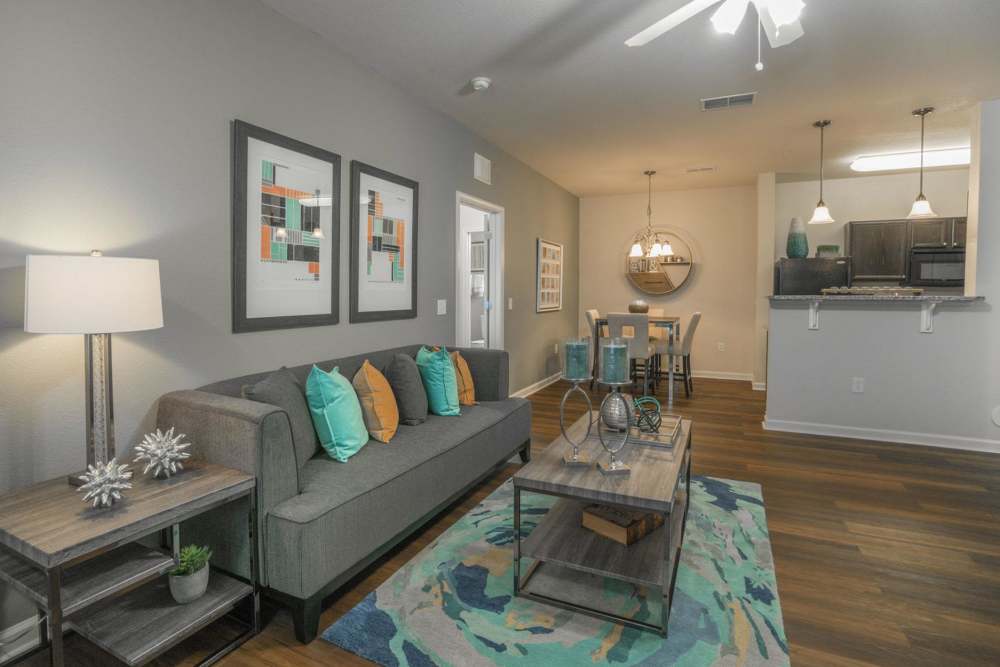 Living room with vinyl flooring, couch and coffee table at The Haven At West Melbourne in West Melbourne, Florida