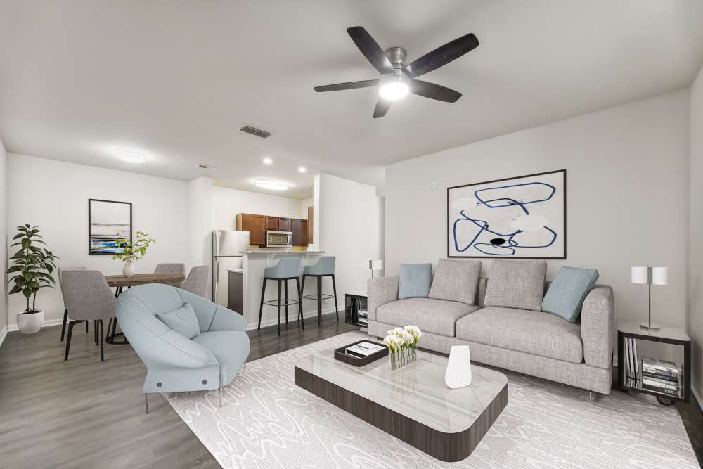 Spacious living room with a comfortable couch, ceiling fan and a coffee table at The Haven At West Melbourne in West Melbourne, Florida