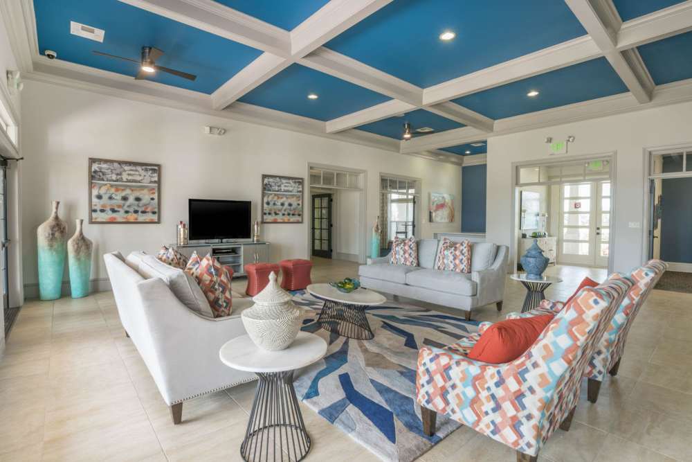 Spacious clubhouse with multiple seating and a large TV at The Haven At West Melbourne in West Melbourne, Florida