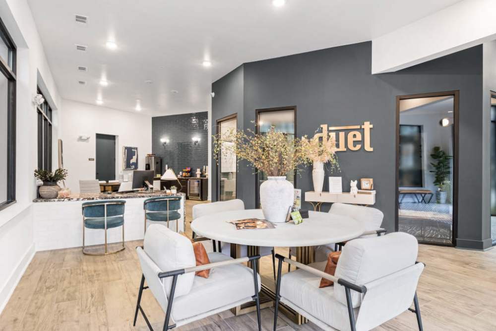 Modern apartment building lobby featuring a dining table and chairs at Duet, Nashville, Tennessee.