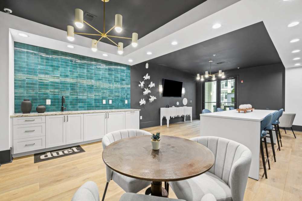 A kitchen featuring blue tile and white chairs, located at Duet in Nashville, Tennessee.