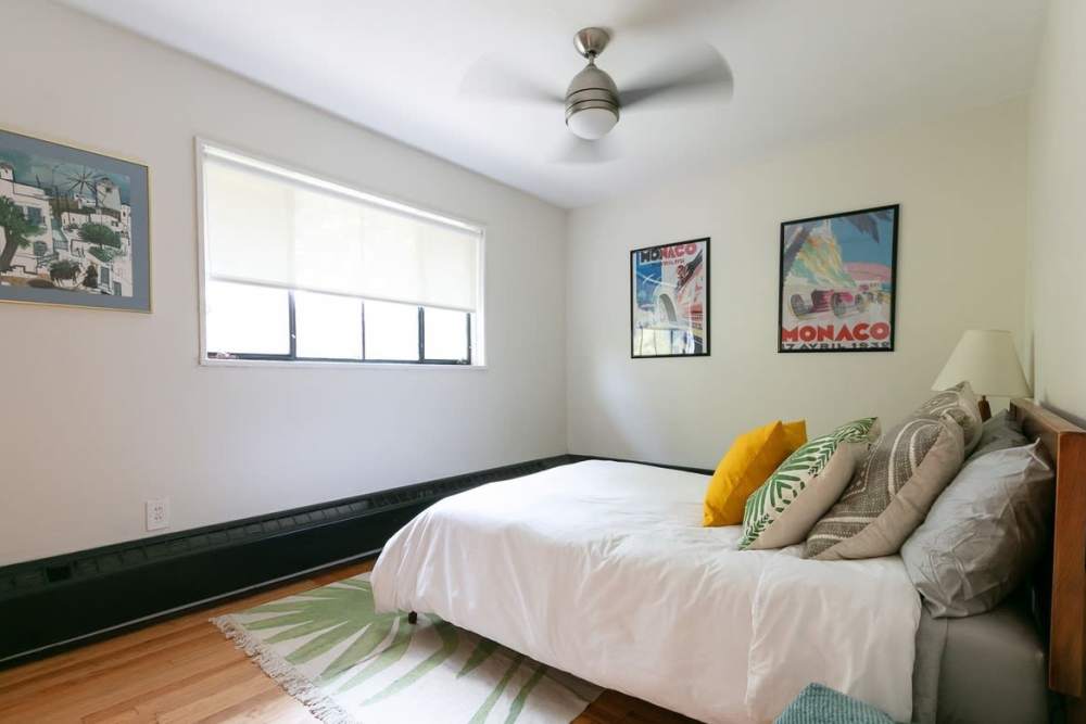 Bedroom with ceiling fan at Detroit Living in Detroit, Michigan