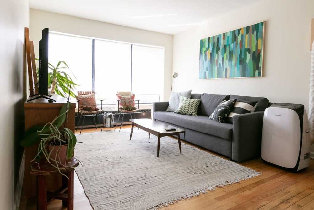 Open layout living room with couch at Detroit Living in Detroit, Michigan