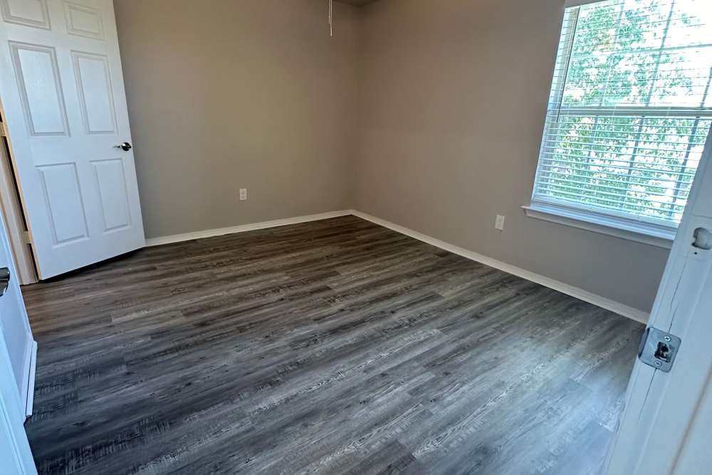 Well-lit bedroom with a large window at Garrett's Landing in Lawton, Oklahoma