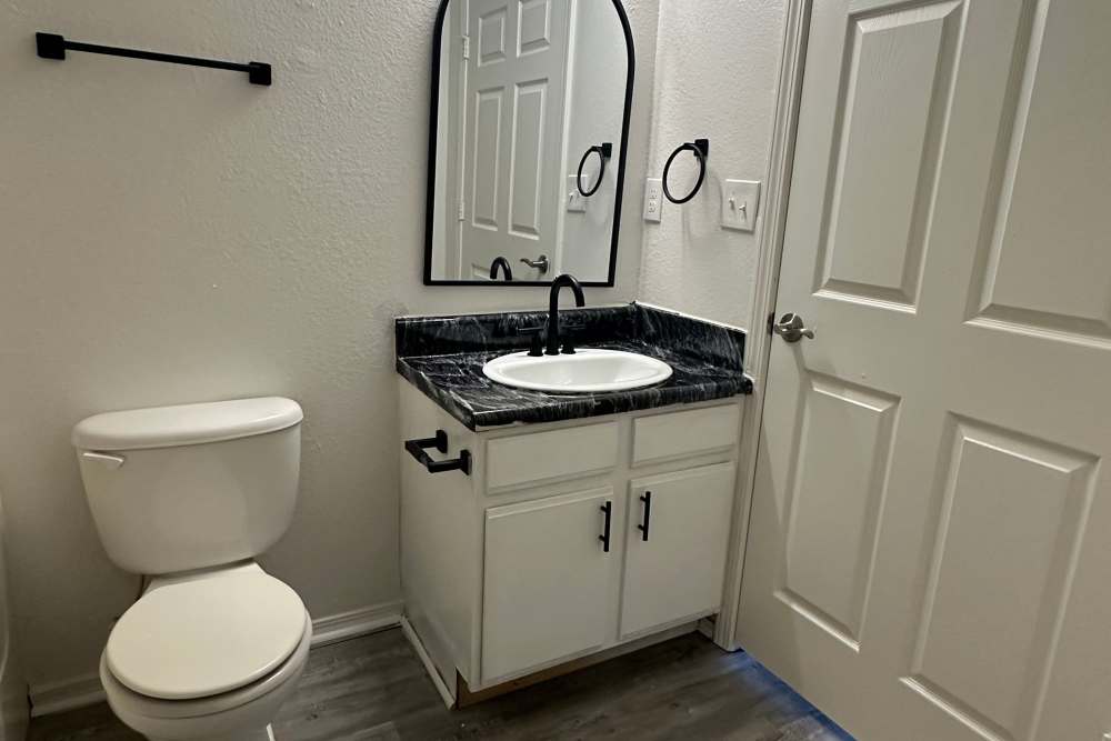 Bathroom with a toilet and a mirror at Garrett's Landing in Lawton, Oklahoma