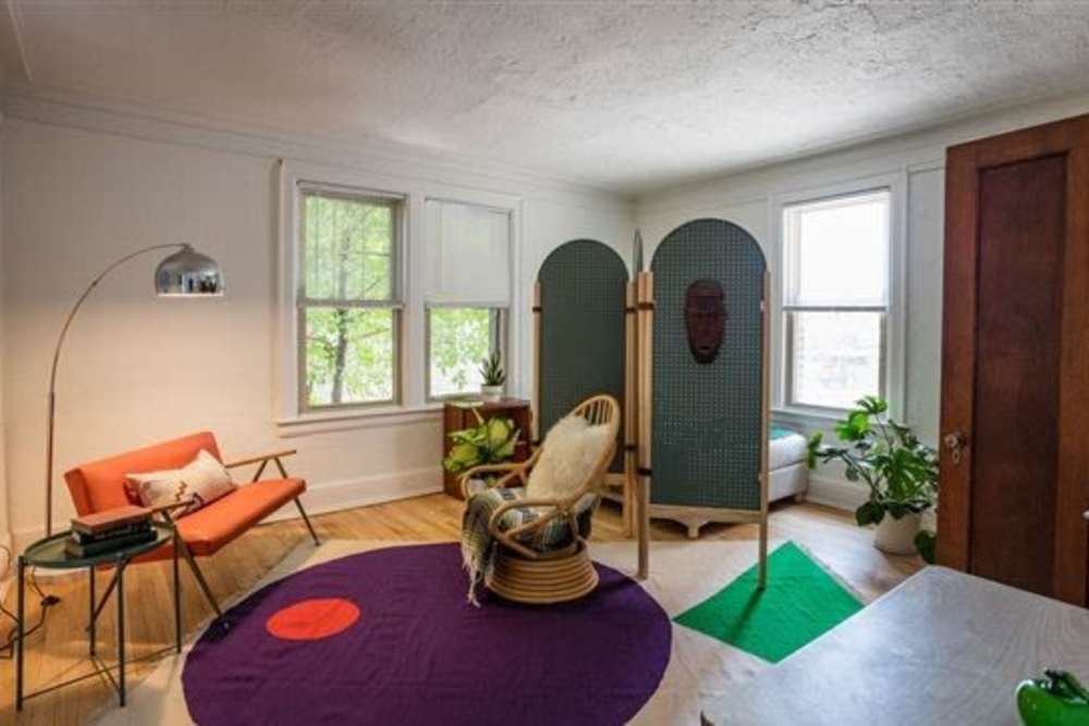 Living room with a dresser and a mirror in it at Detroit Living in Detroit,Michigan