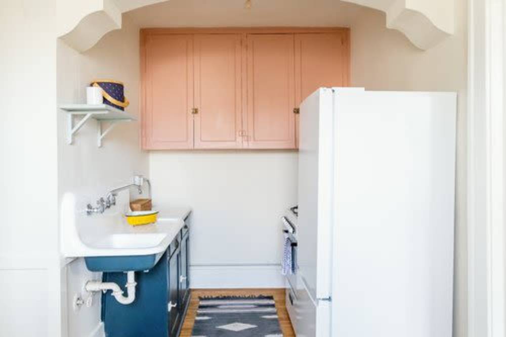 Apartment kitchen with blue cabinetry at Detroit Living in Detroit,Michigan