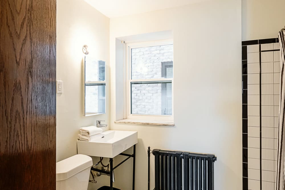 Bathroom with waterfall faucet sink at Detroit Living in Detroit, Michigan