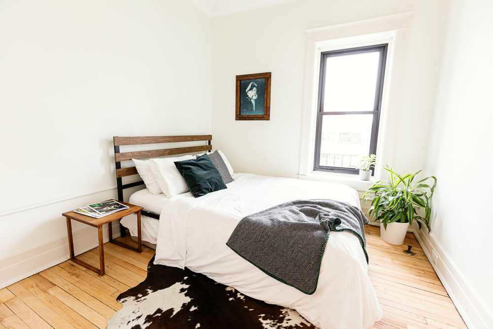Bright bedroom with window at Detroit Living in Detroit, Michigan