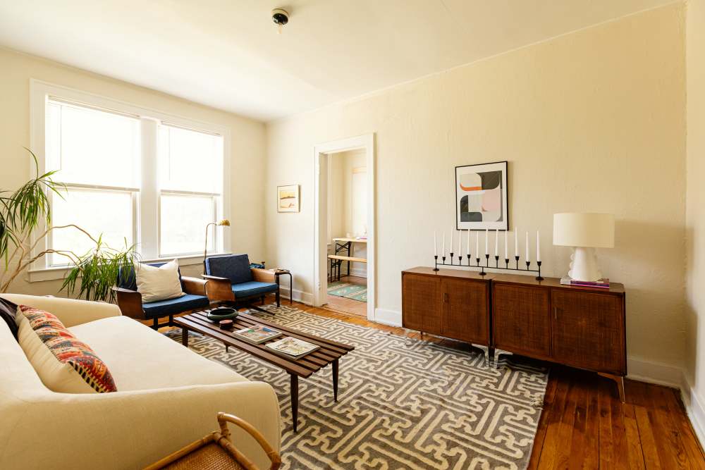 Classy living room with dark colored storage units at Detroit Living in Detroit,Michigan