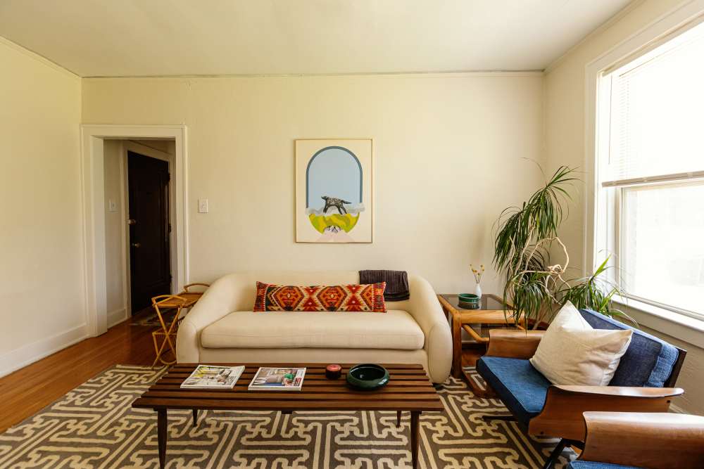 Cozy living room with a couch and a rug at Detroit Living in Detroit,Michigan