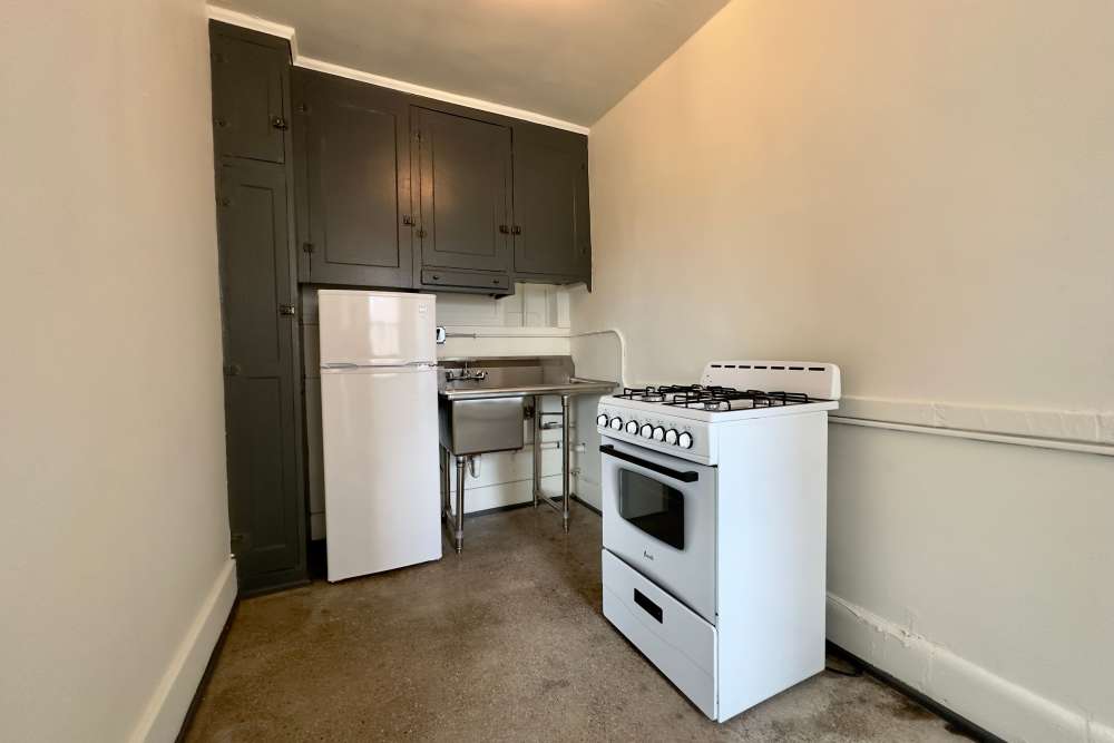 Apartment kitchen with white appliances at Detroit Living in Detroit,Michigan