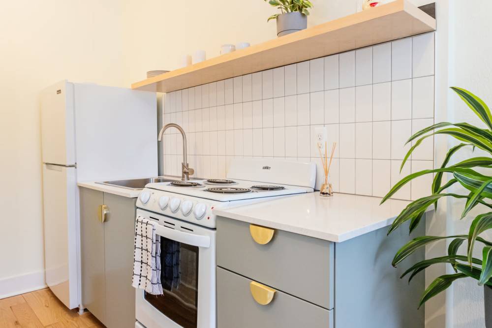 Apartment kitchen with white refrigerator at Detroit Living in Detroit,Michigan