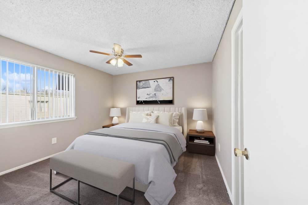 Cozy bedroom with a ceiling fan with lights and frame at Cypress Point Apartments in Shawnee, Oklahoma