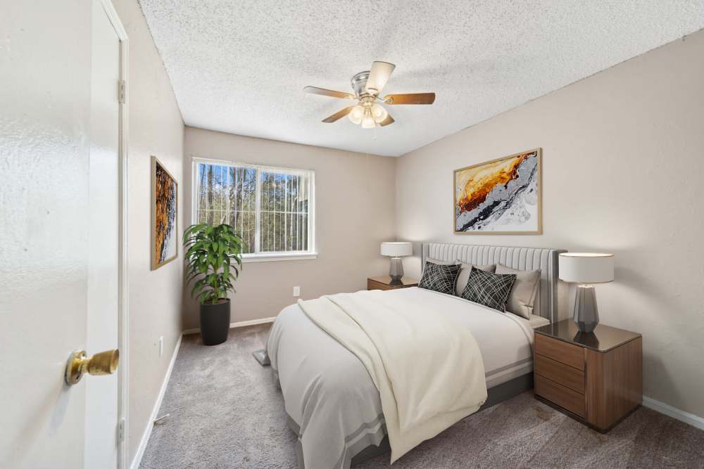 Small cozy bedroom with two bedside table and lamps at Cypress Point Apartments in Shawnee, Oklahoma
