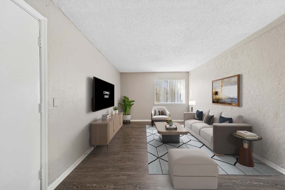 Different angle of spacious living room space showing a television and furniture at Cypress Point Apartments in Shawnee, Oklahoma