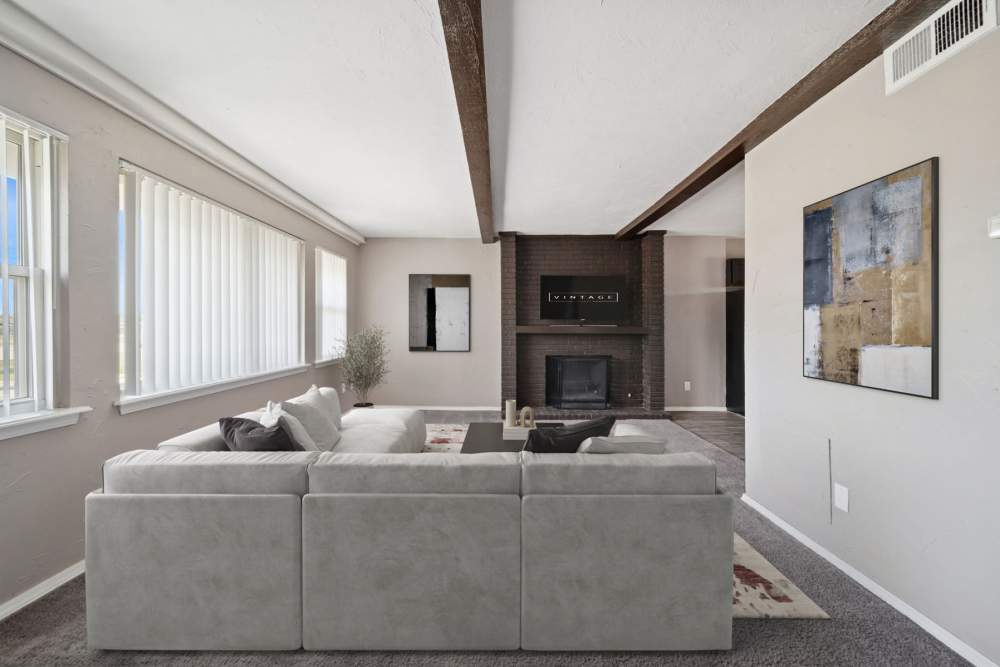 Living room with couches and fireplace and television at Vintage At 50th in Oklahoma City, Oklahoma