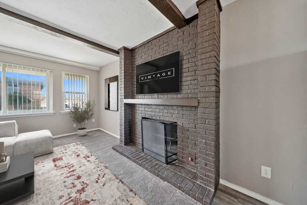 Liivng room area showcasing the fireplace and television above at Vintage At 50th in Oklahoma City, Oklahoma