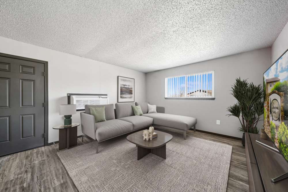 Living room area with couches and mini center table facing the television at Sherwood Pointe Apartments in Shawnee, Oklahoma