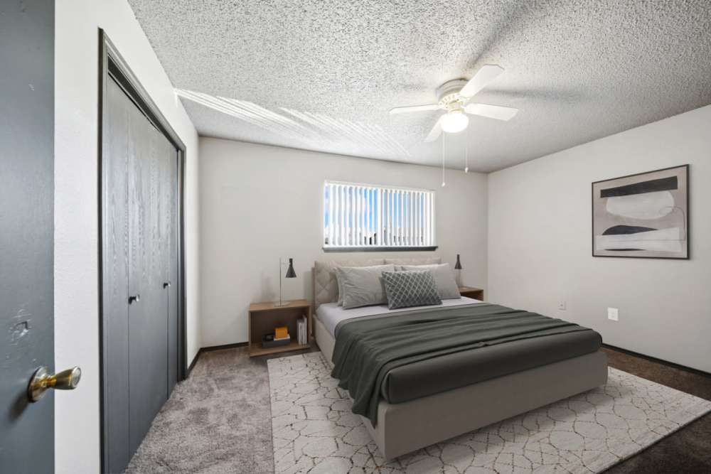 Cozy bedroom with closet and two bedside table with lamps at Sherwood Pointe Apartments in Shawnee, Oklahoma