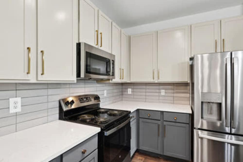 Kitchen with wooden cabinets and stainless-steel appliances  at Barron Park in Pearland, Texas