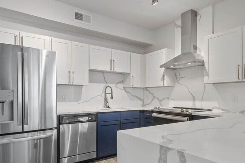 Kitchen with stainless-steel appliances including refrigerator & dishwasher at The Lofts At West 7th in Fort Worth,Texas