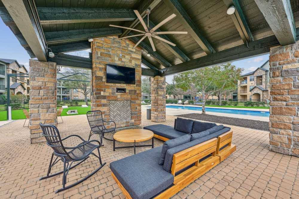 Outdoor seating area with a TV at Barron Park in Pearland, Texas