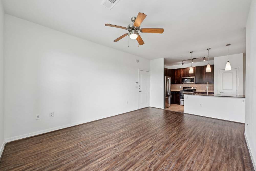 Living room with view of the kitchen at Barron Park in Pearland, Texas