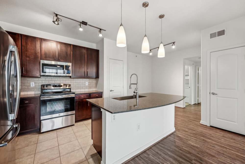 Modern kitchen with wooden cabinets at Barron Park in Pearland, Texas