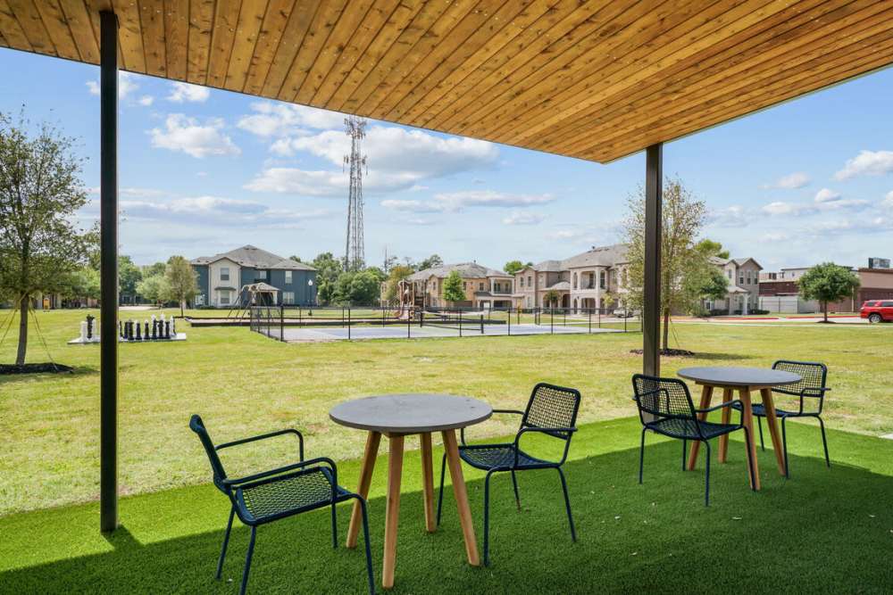 Exterior seating area with tables at Seagrove in Conroe, Texas