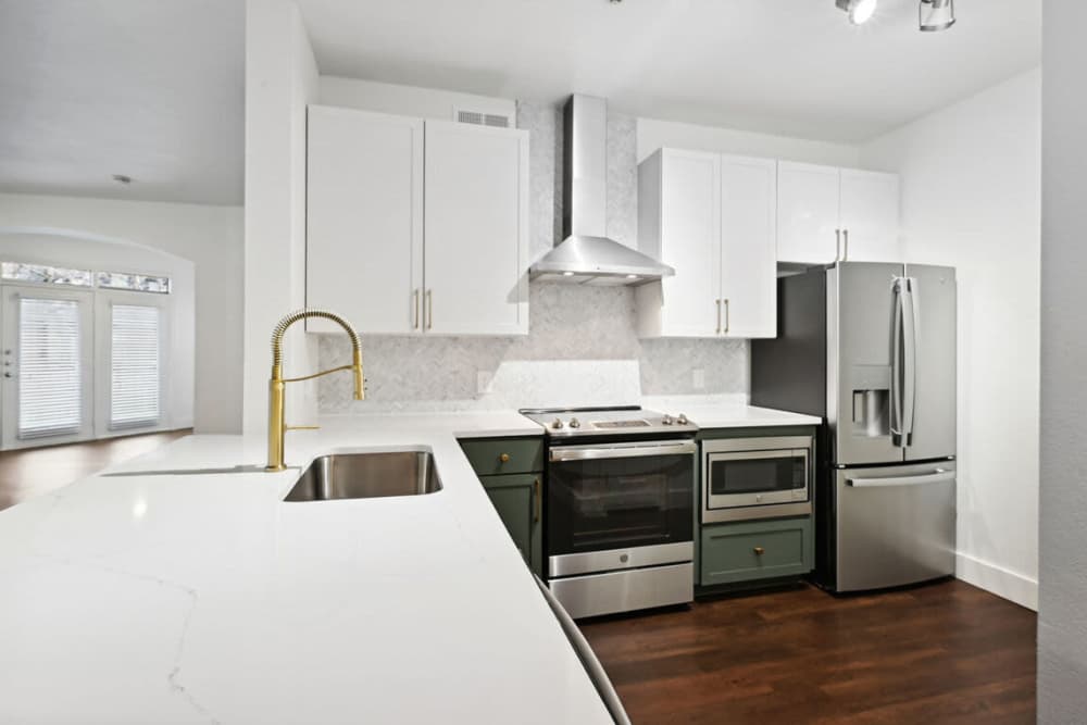 Modern kitchen with stainless-steel appliances at Dorian and Encore in Plano, Texas