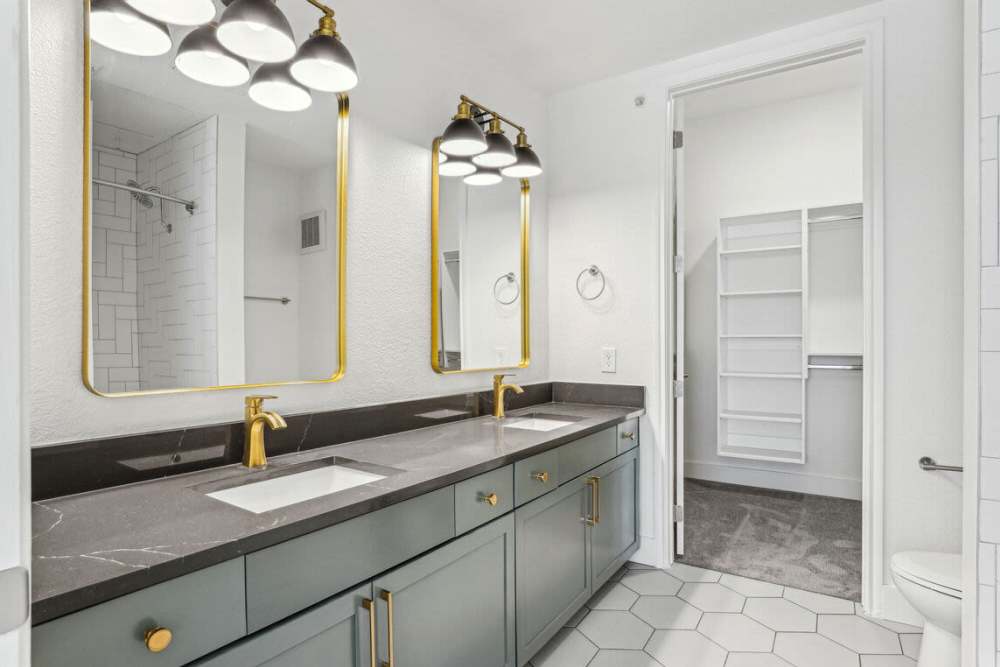 Bathroom with pendant lighting and double vanity storage at Dorian and Encore in Plano, Texas