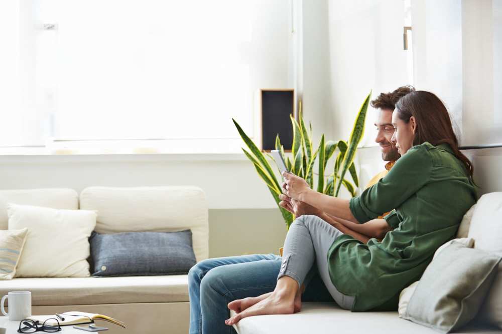 Happy couple in living room at Detroit Living in Detroit, 